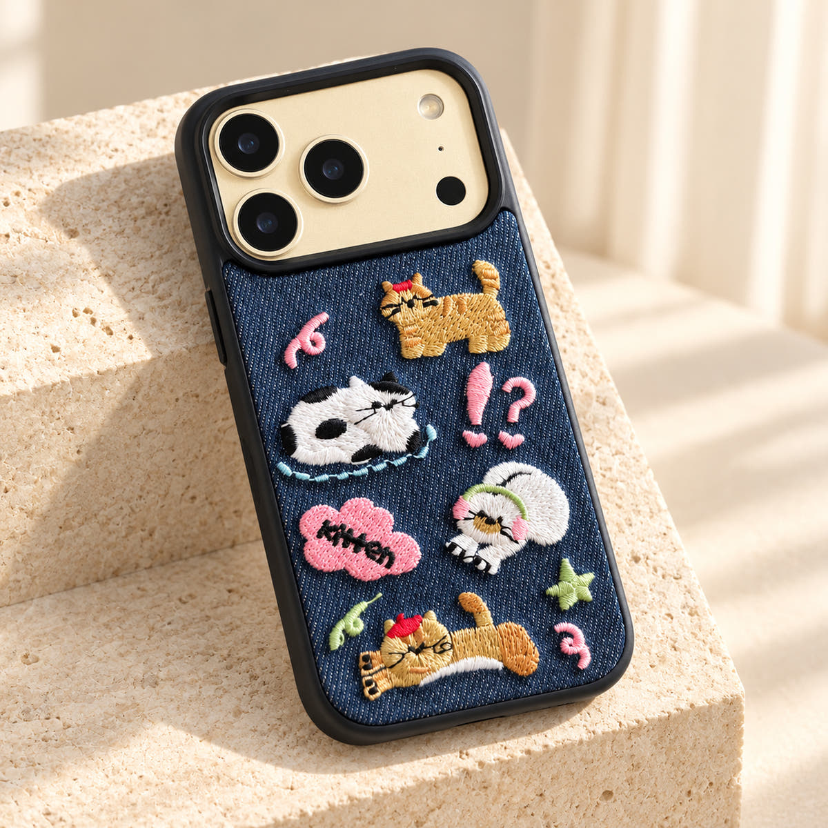 Kawaii Cat Embroidered Denim iPhone case — tabletop diagonal view