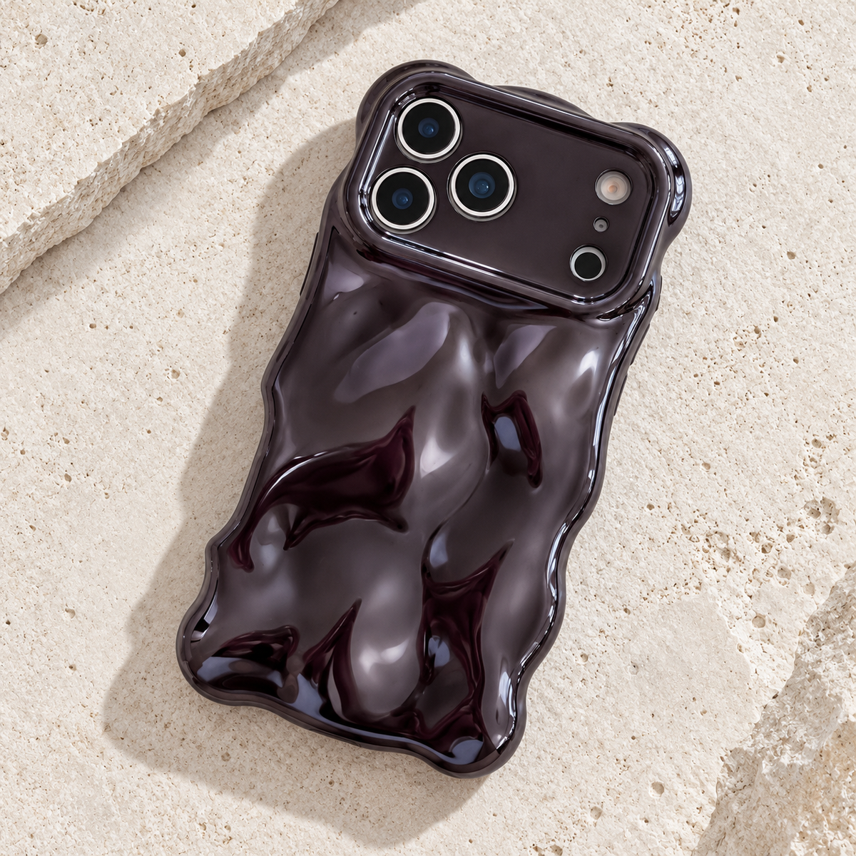 Diagonal flat-lay of the Black Liquid Chrome Wave case showing its wavy outline.