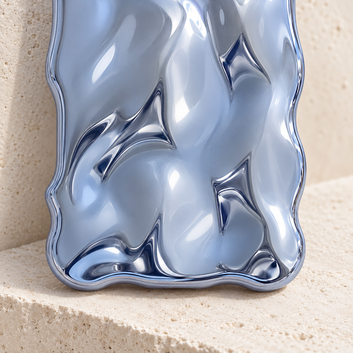 Close-up of the Blue Liquid Chrome Wave case's rippled finish and lower curved edge.