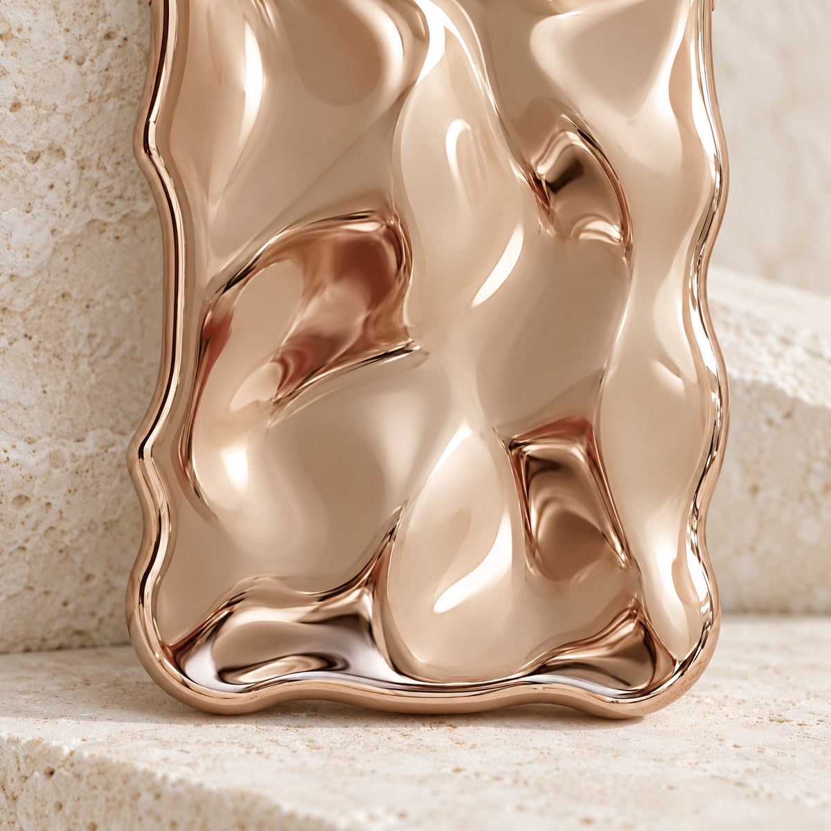 Close-up of the Champagne Liquid Chrome Wave case's rippled finish and lower curved edge.