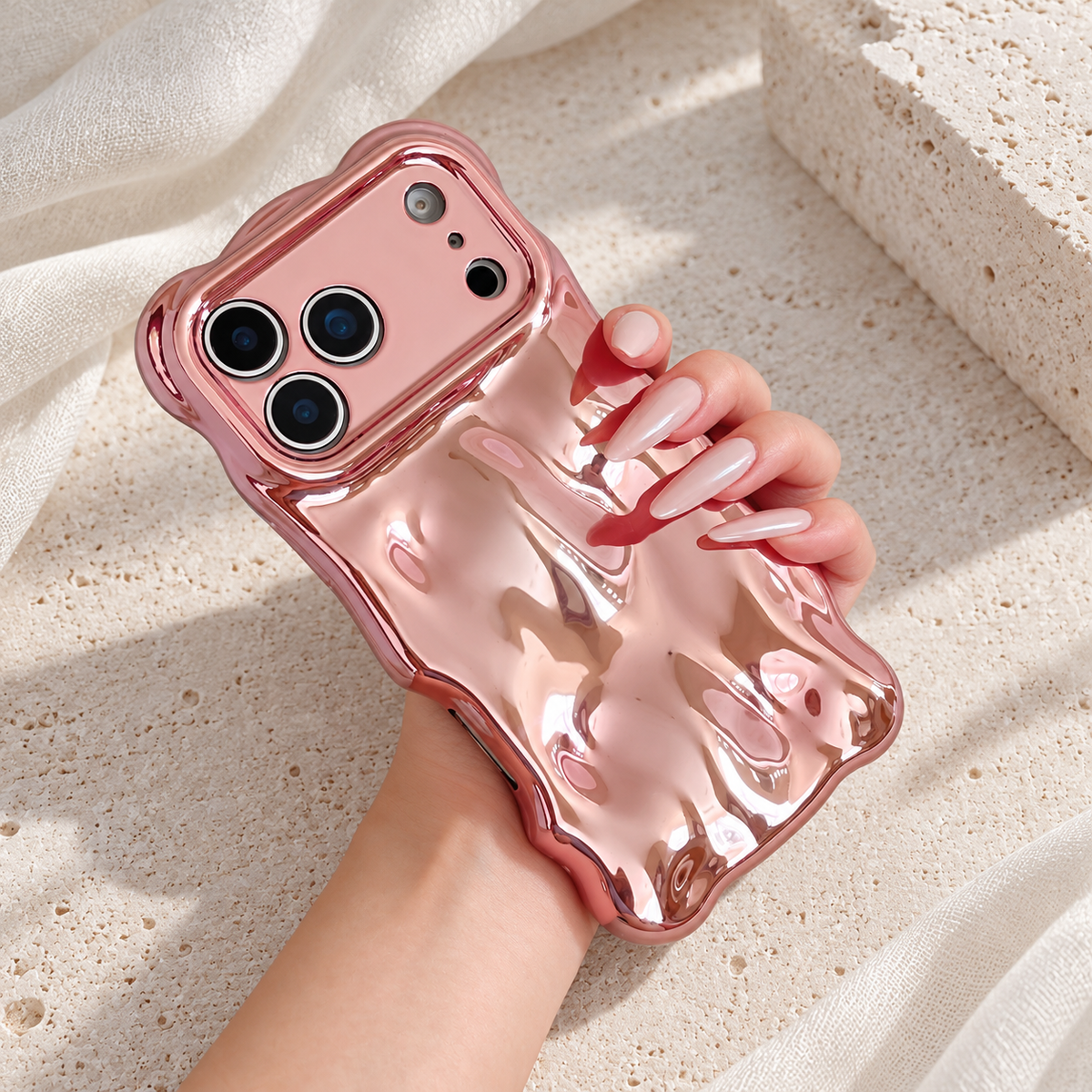 Liquid Chrome Wave iPhone case in Rose Pink shown in a natural lifestyle view.