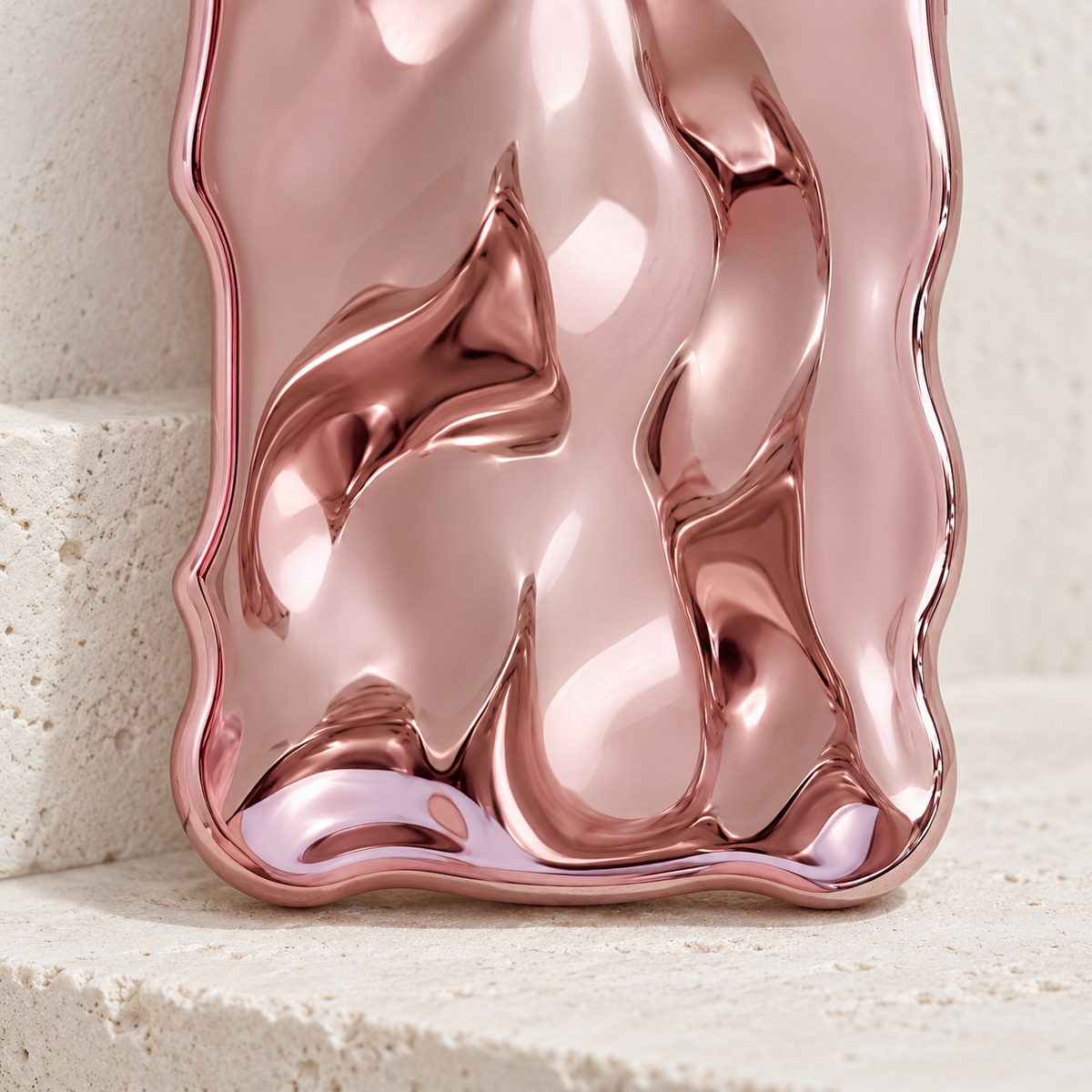 Close-up of the Rose Pink Liquid Chrome Wave case's rippled finish and lower curved edge.