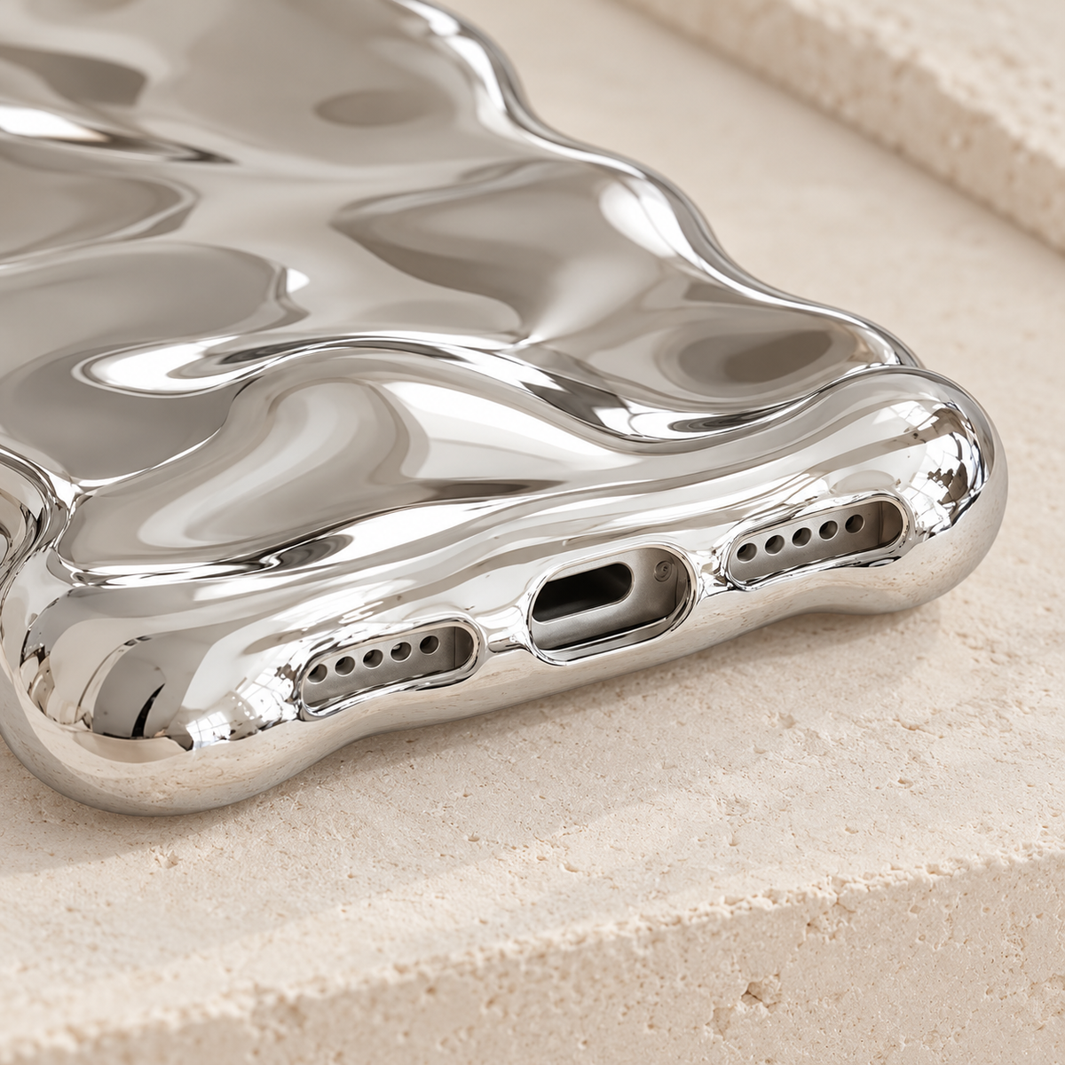 Silver Liquid Chrome Wave case bottom-edge detail with the photographed port openings.