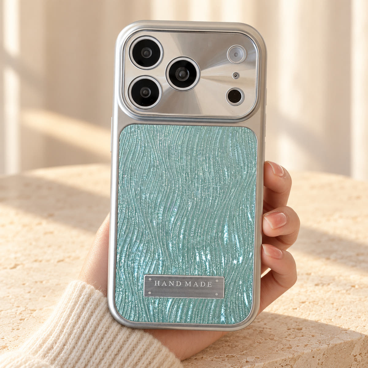 Luna Belle textured shimmer iPhone case in Ice Blue, held upright.