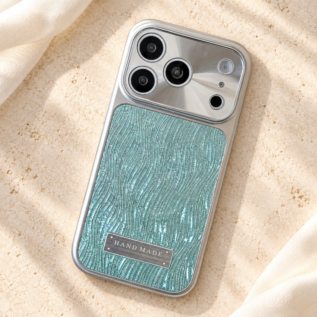 Luna Belle textured shimmer iPhone case in Ice Blue, resting on cream stone.