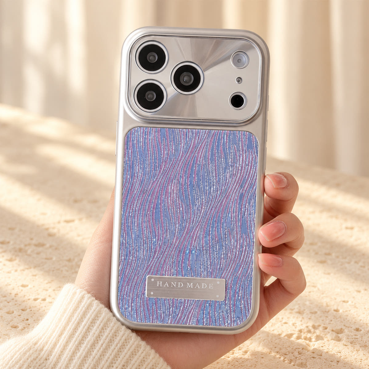 Luna Belle textured shimmer iPhone case in Purple, held upright.