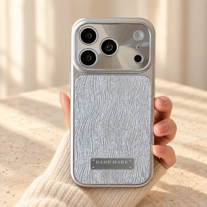 Luna Belle textured shimmer iPhone case in Silver, held upright.