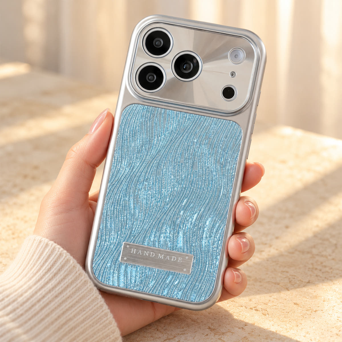 Luna Belle textured shimmer iPhone case in Sky Blue, shown at a rear three-quarter angle.
