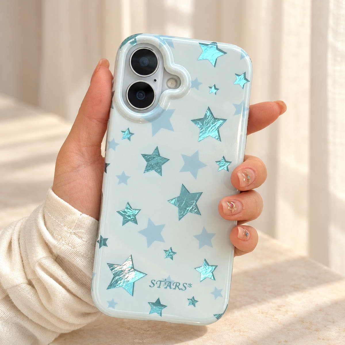 Metallic Dots & Stars iPhone case in Blue — handheld view