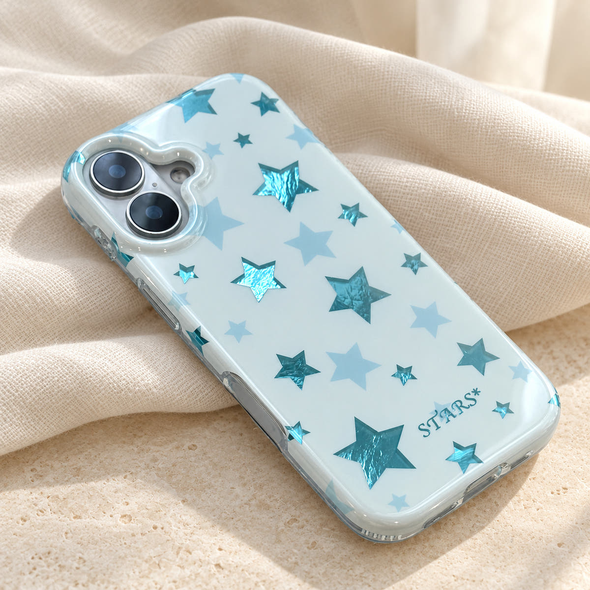 Metallic Dots & Stars iPhone case in Blue — linen flatlay view