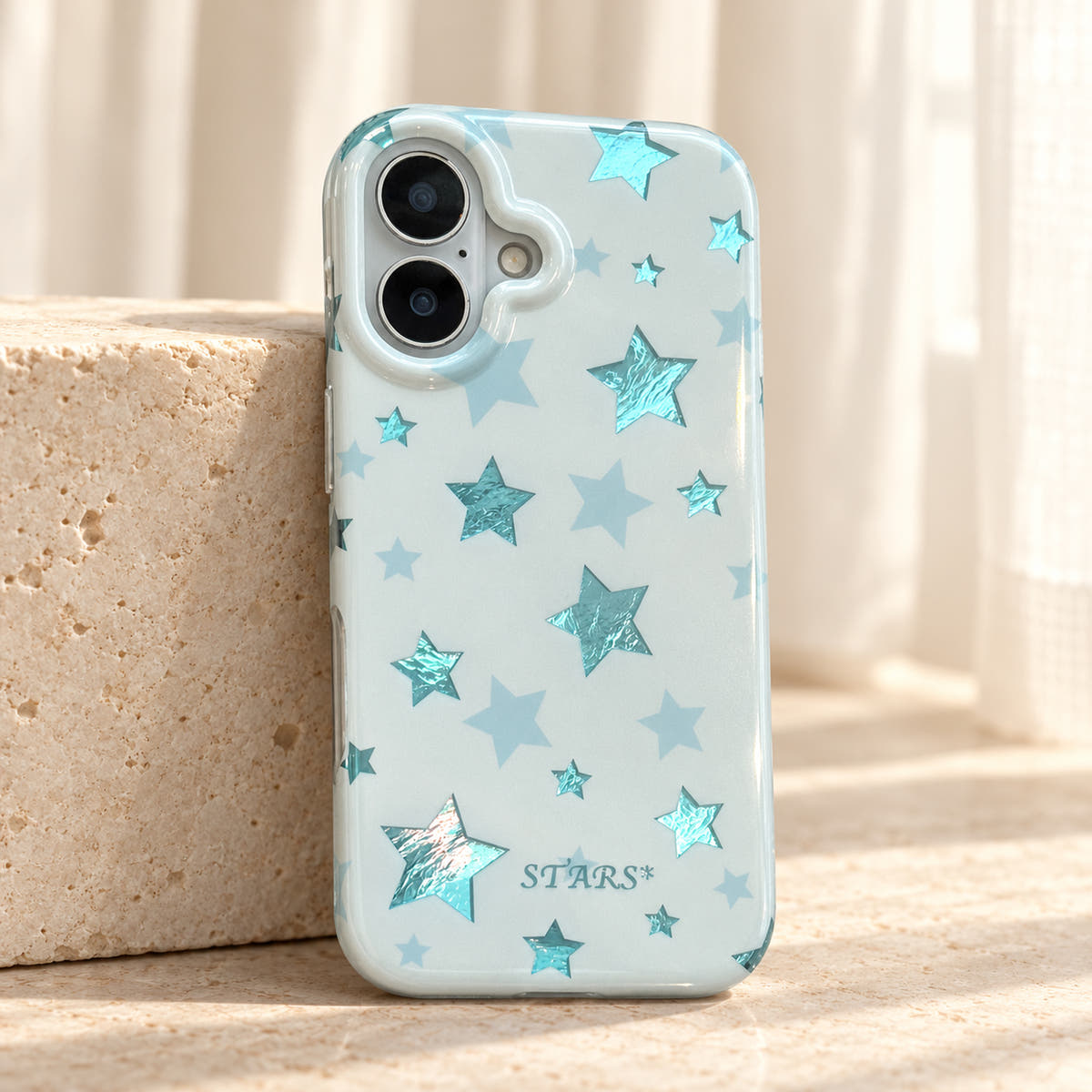 Metallic Dots & Stars iPhone case in Blue — studio view
