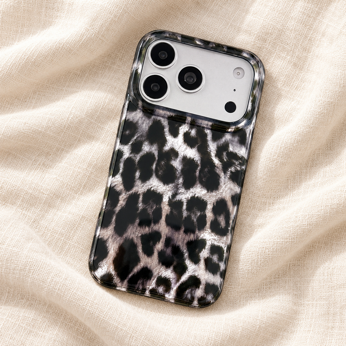 Full back of the black and silver leopard print case on ivory linen.