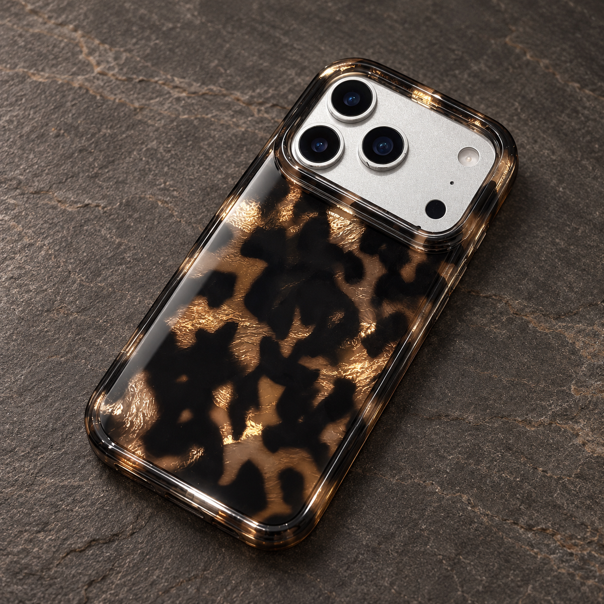 Dark Tortoiseshell iPhone case with black and warm brown mottled pattern — gloss finish under side light.