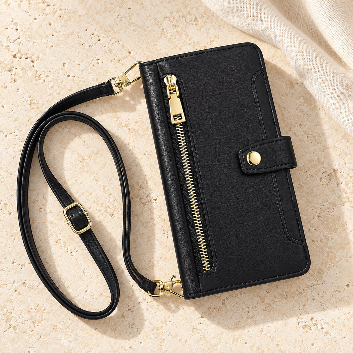 Minimal crossbody iPhone wallet case in Black — overhead front view with matching adjustable shoulder strap