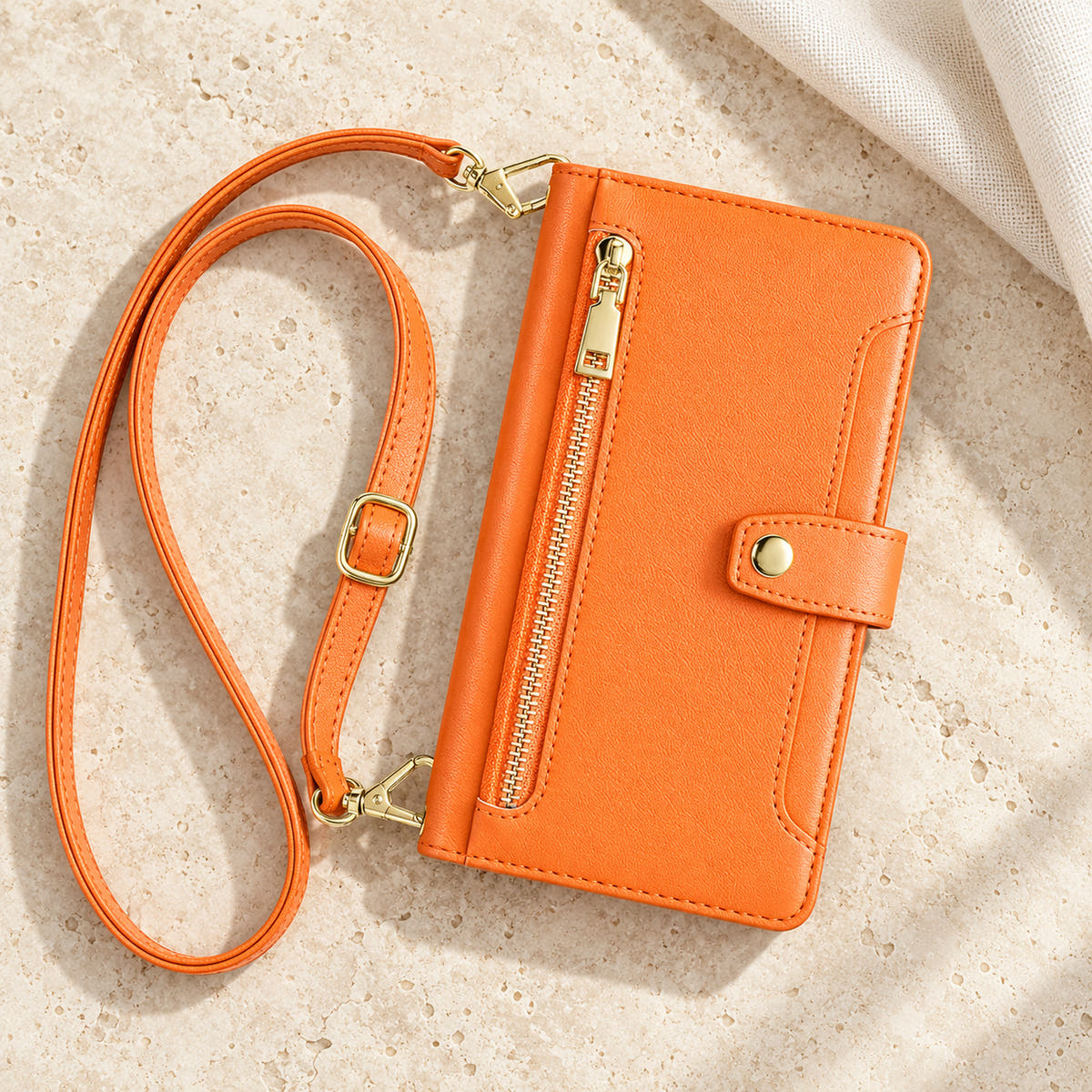 Minimal crossbody iPhone wallet case in Orange — overhead front view with matching adjustable shoulder strap