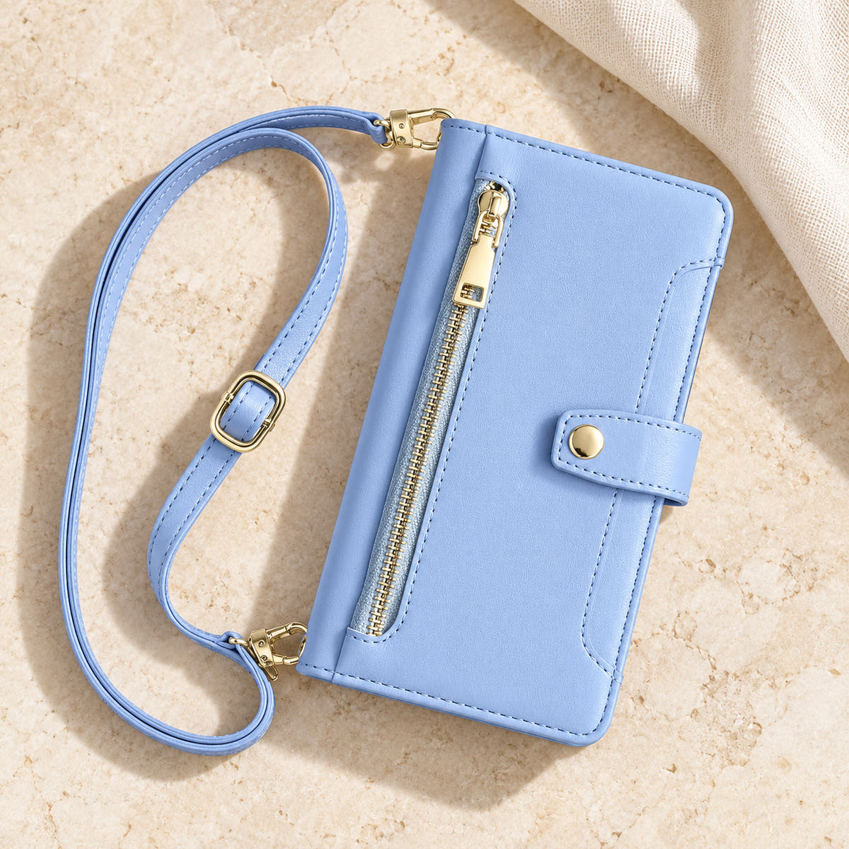 Minimal crossbody iPhone wallet case in Sky Blue — overhead front view with matching adjustable shoulder strap