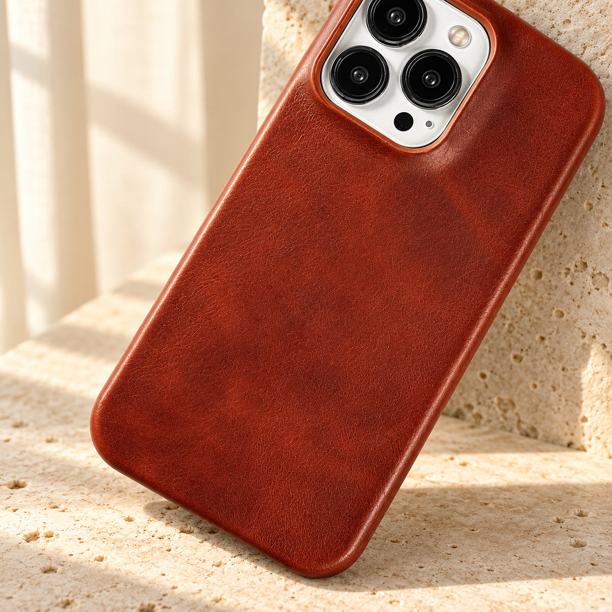 Minimal leather-look iPhone case in Brown, close-up of the fine-grained back and rounded corners.