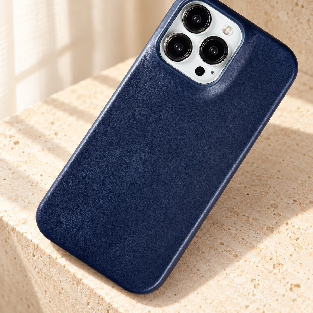 Minimal leather-look iPhone case in Midnight Blue, close-up of the fine-grained back and rounded corners.