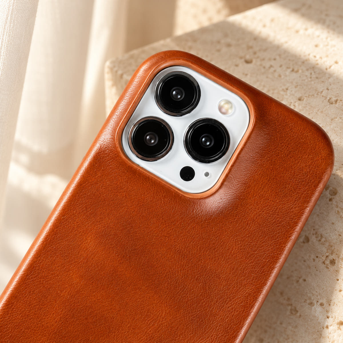 Minimal leather-look iPhone case in Orange Red, close-up of the matching camera border.