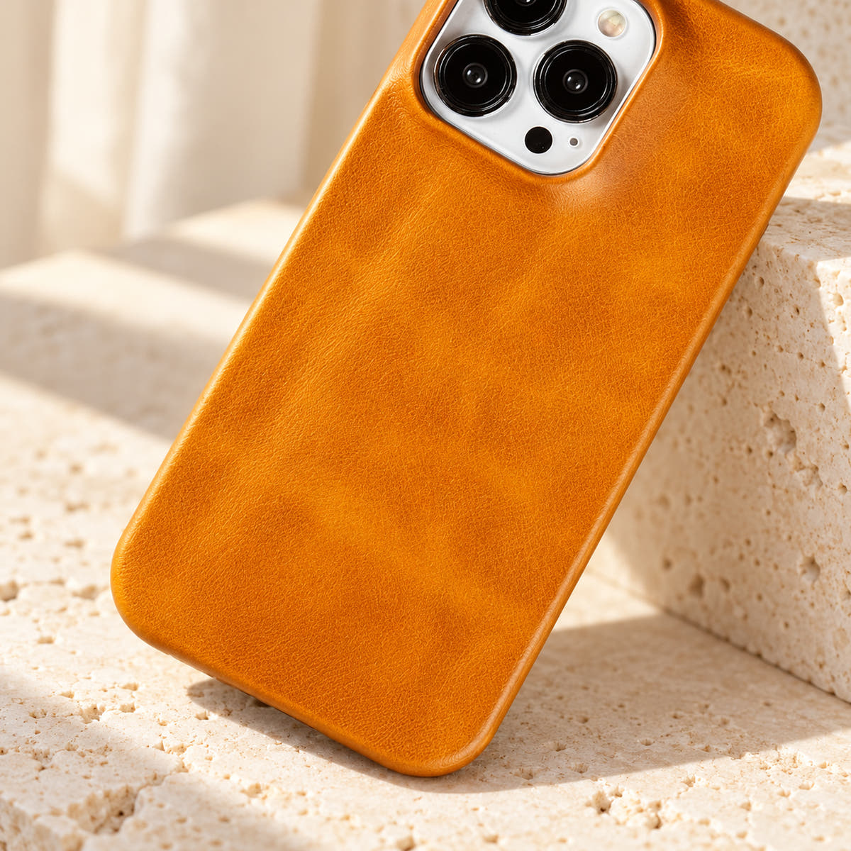 Minimal leather-look iPhone case in Yellow, close-up of the fine-grained back and rounded corners.