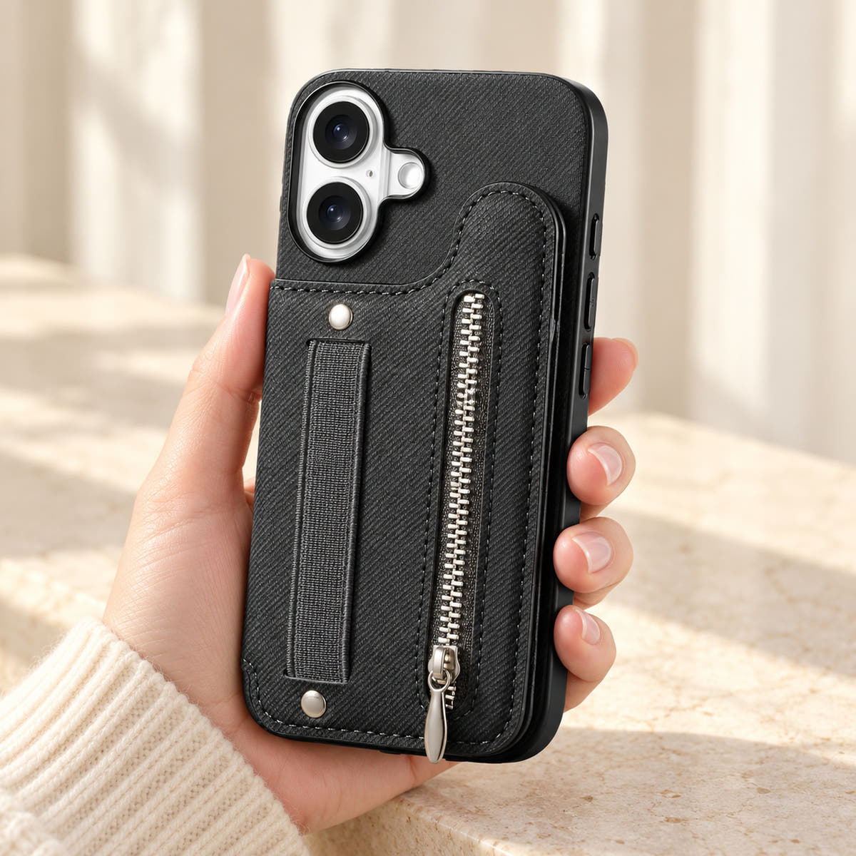 Multi-Pocket iPhone wallet case in Black held upright, showing the rear wallet, fabric hand strap and silver zip