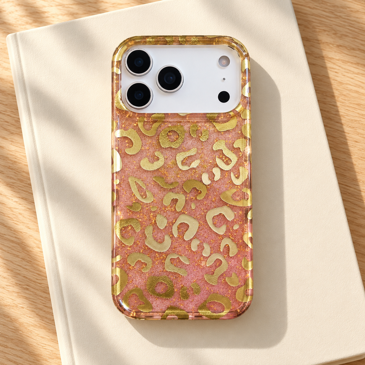 Golden Blush Leopard case on a plain cream notebook.