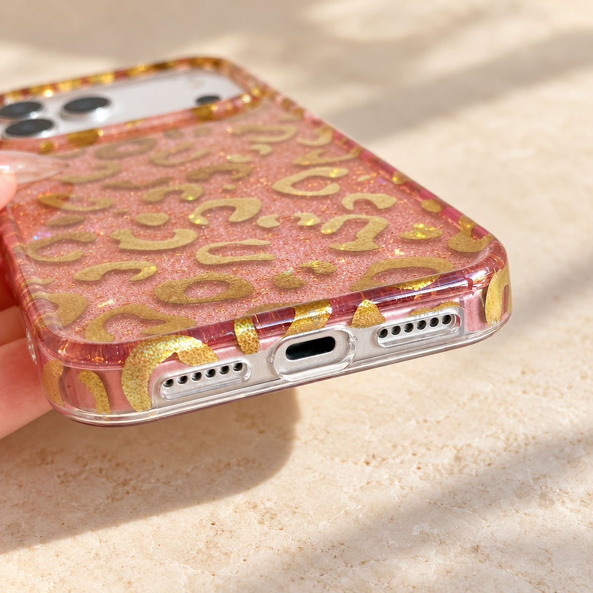 Close-up of the Pink & Gold case's clear lower edge and observed port openings.