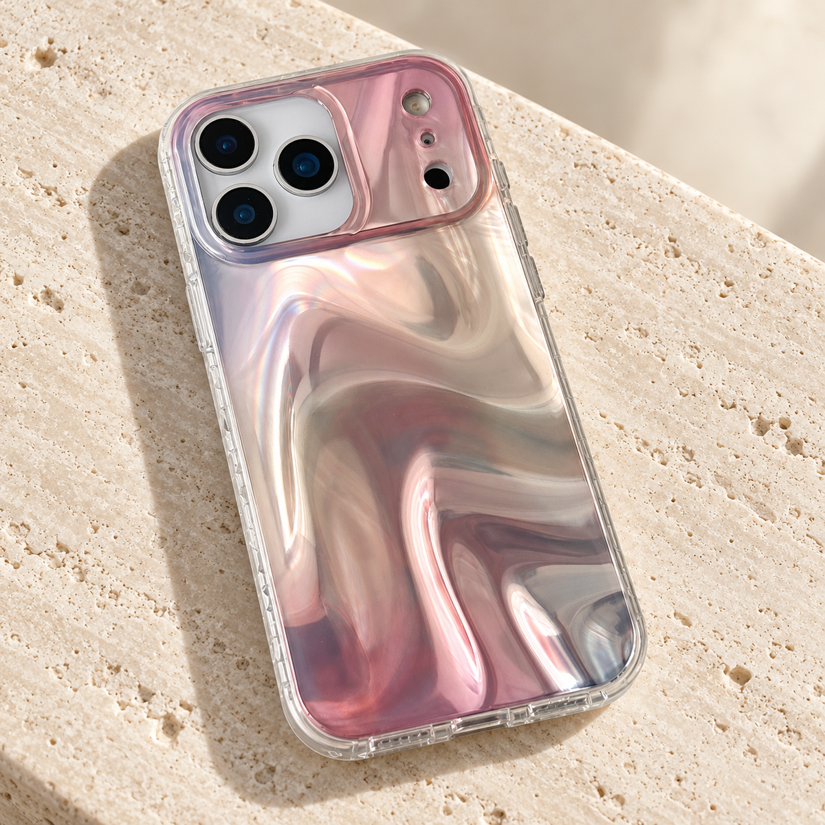 Iridescent Rose case lying diagonally on pale travertine.