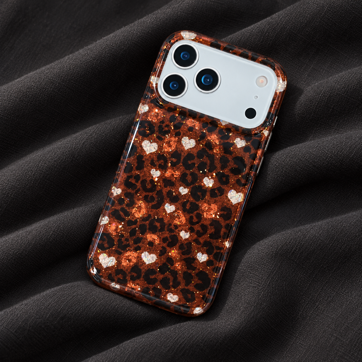 Amber Leopard Heart case shown in full on softly folded charcoal fabric.