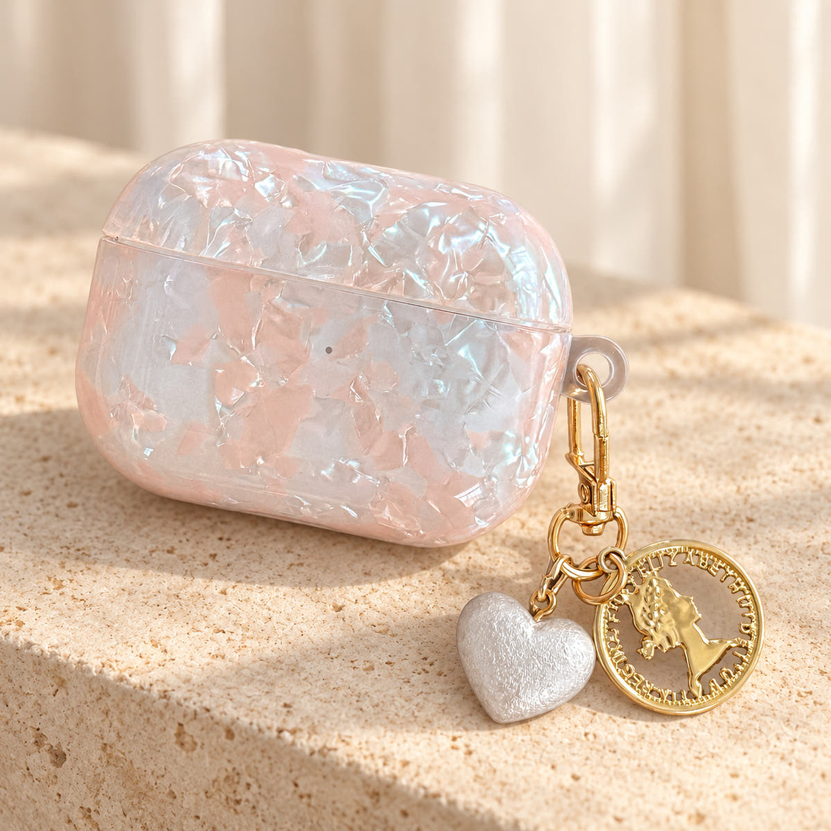 Opal Marble AirPods Case in Opal, stone step with original attached charms on a warm cream background