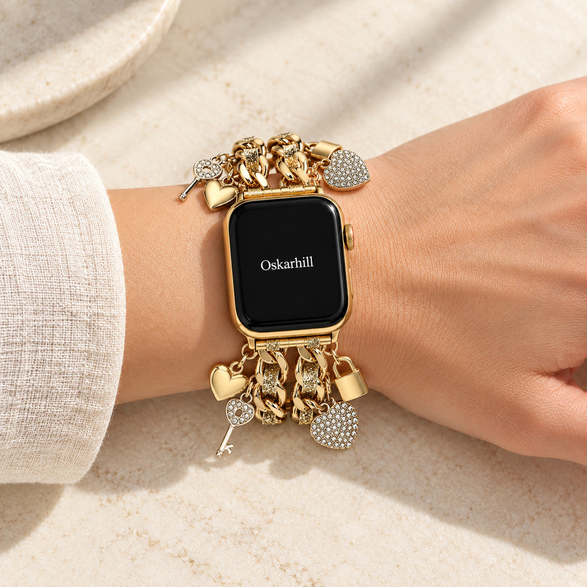 Oskar Hill Amorette Apple Watch charm band — on a feminine wrist with visible charm details