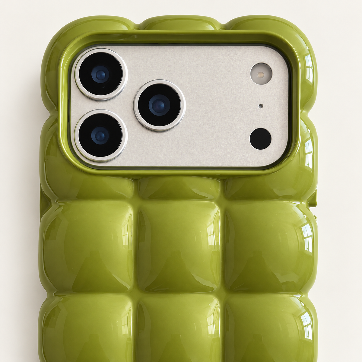 Olive Green puffy grid iPhone case with rounded-square back and scalloped edges — close-up of camera surround and sculpted grid.