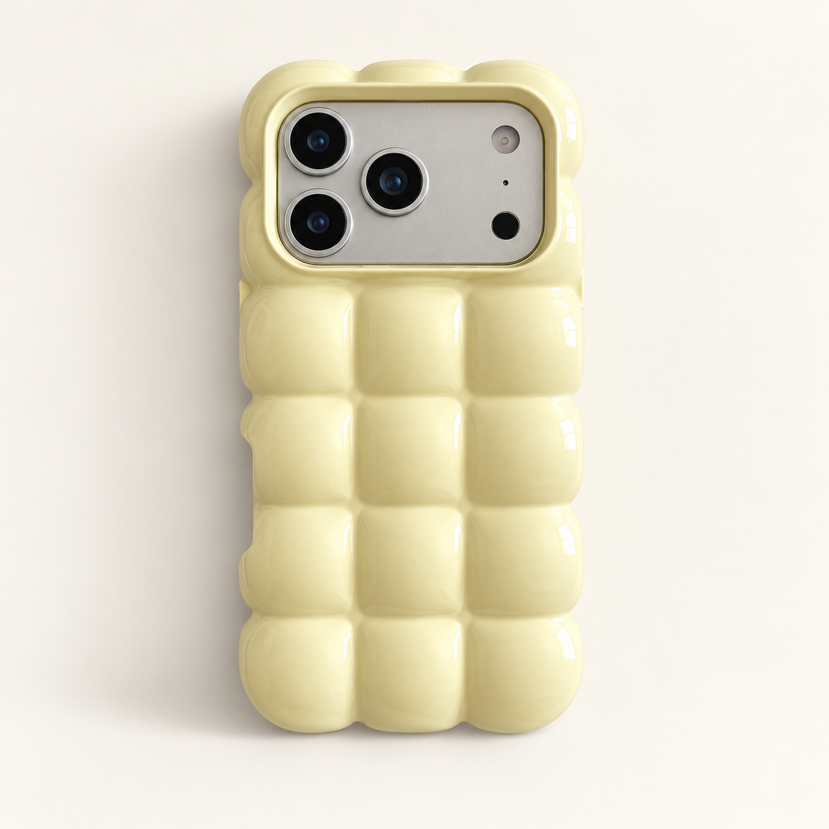 Pale Yellow puffy grid iPhone case with rounded-square back and scalloped edges — full rear studio view.