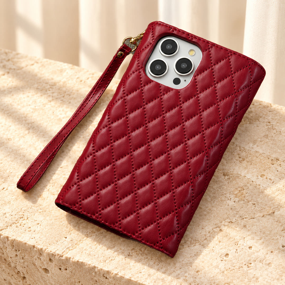 Rear view of the Red Quilted Zip Wallet iPhone case, showing the diamond-quilted back, camera opening and detachable wrist loop.