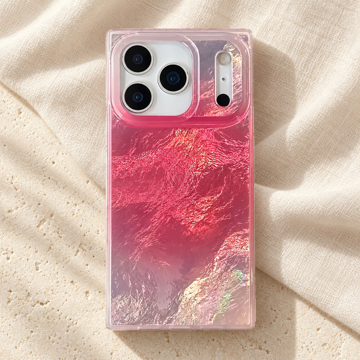 Radiant Wave iPhone case laid on ivory linen and cream limestone