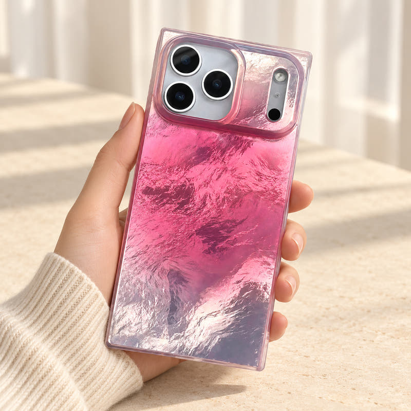 Radiant Wave pink iridescent iPhone case held upright, showing the wave-textured reflective back and wide camera surround