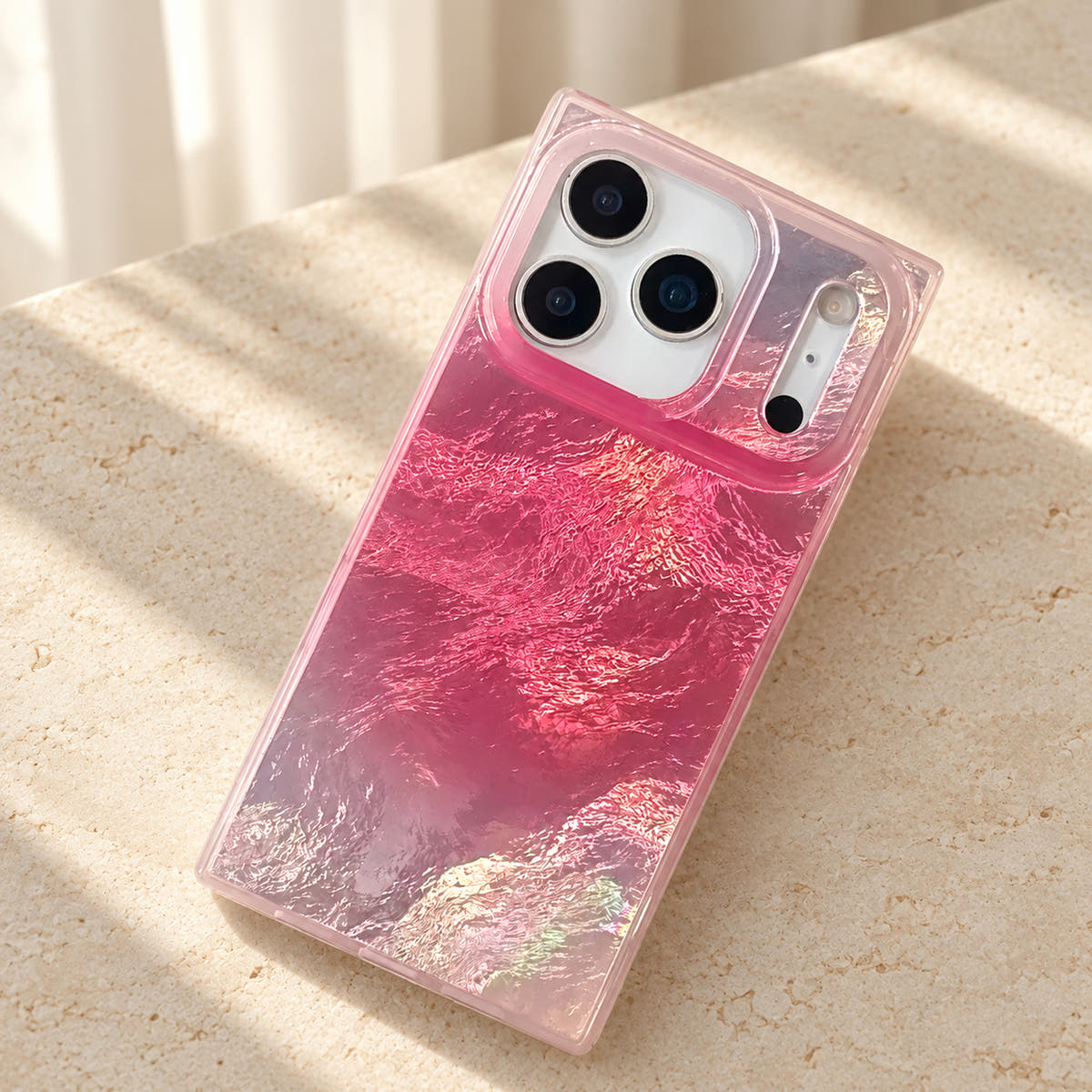 Portrait tabletop view of the Radiant Wave reflective pink iPhone case