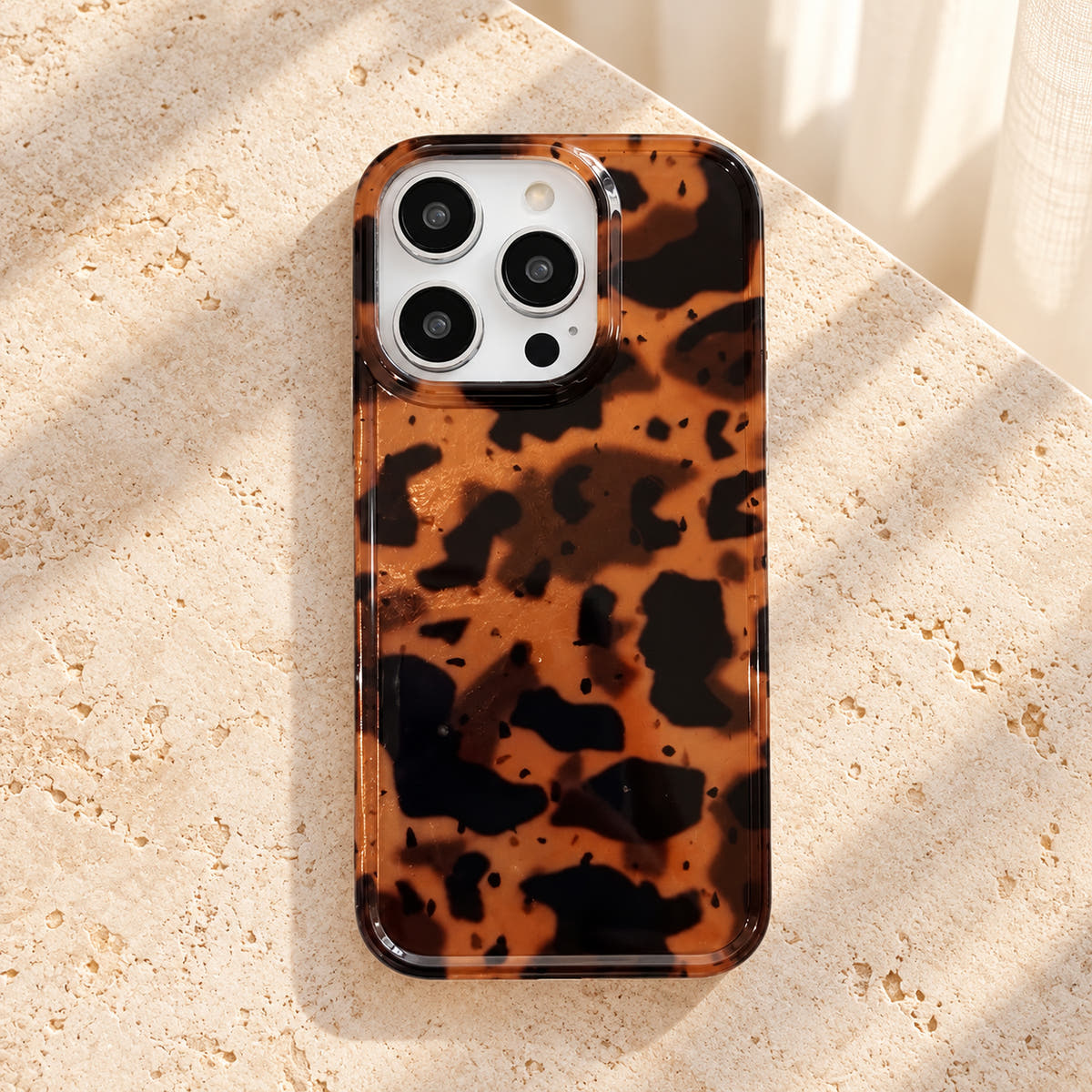Overhead view of the complete Sienna Luxe Brown iPhone case with amber and dark-brown tortoiseshell artwork.