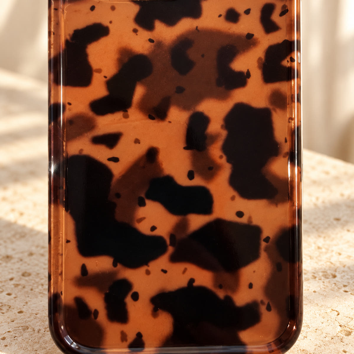 Close detail of Sienna Luxe Brown's amber, deep-brown and near-black tortoiseshell artwork.
