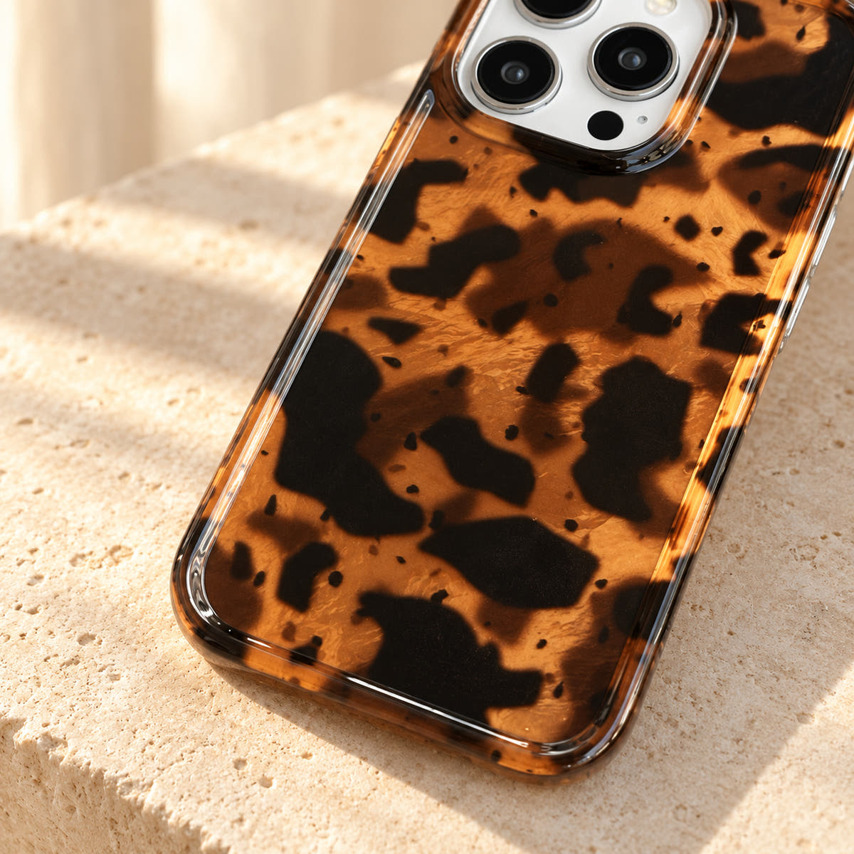 Angled detail of the Sienna Luxe Brown lower print and clear perimeter in warm natural light.