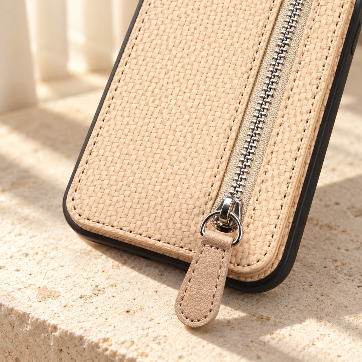 Signature Beige iPhone wallet case in a close-up of the zipper, matching pull tab and woven-look texture.