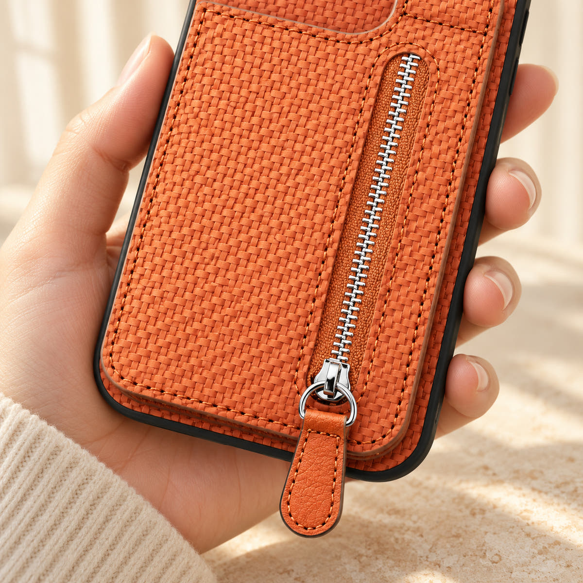 Signature Brown iPhone wallet case in a close-up of the zipper, matching pull tab and woven-look texture.