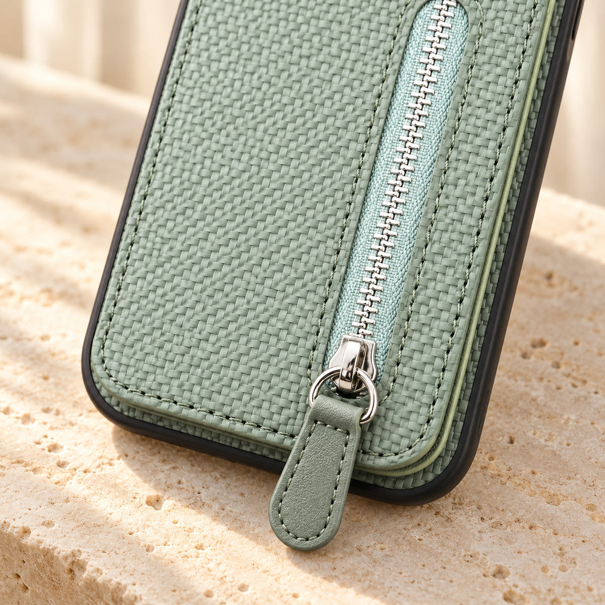 Signature Green iPhone wallet case in a close-up of the zipper, matching pull tab and woven-look texture.