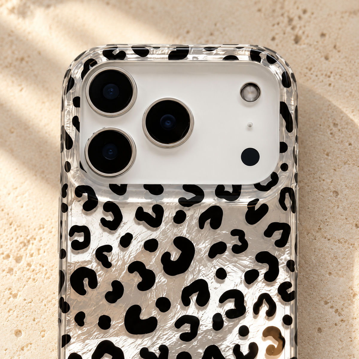 Close-up of the Black leopard iPhone case camera opening and patterned clear upper rim.
