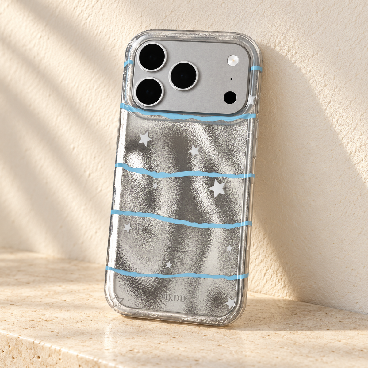 Silver Star Wave case displayed on a pale limestone shelf against a cream wall.