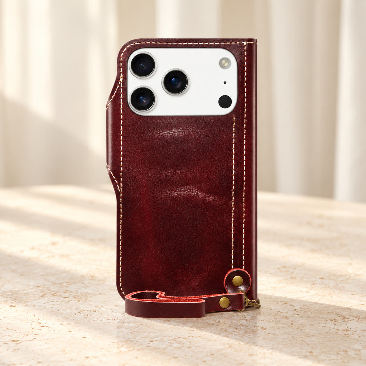 Red stitched wallet case rear view with the original camera opening and matching clip-on wrist loop