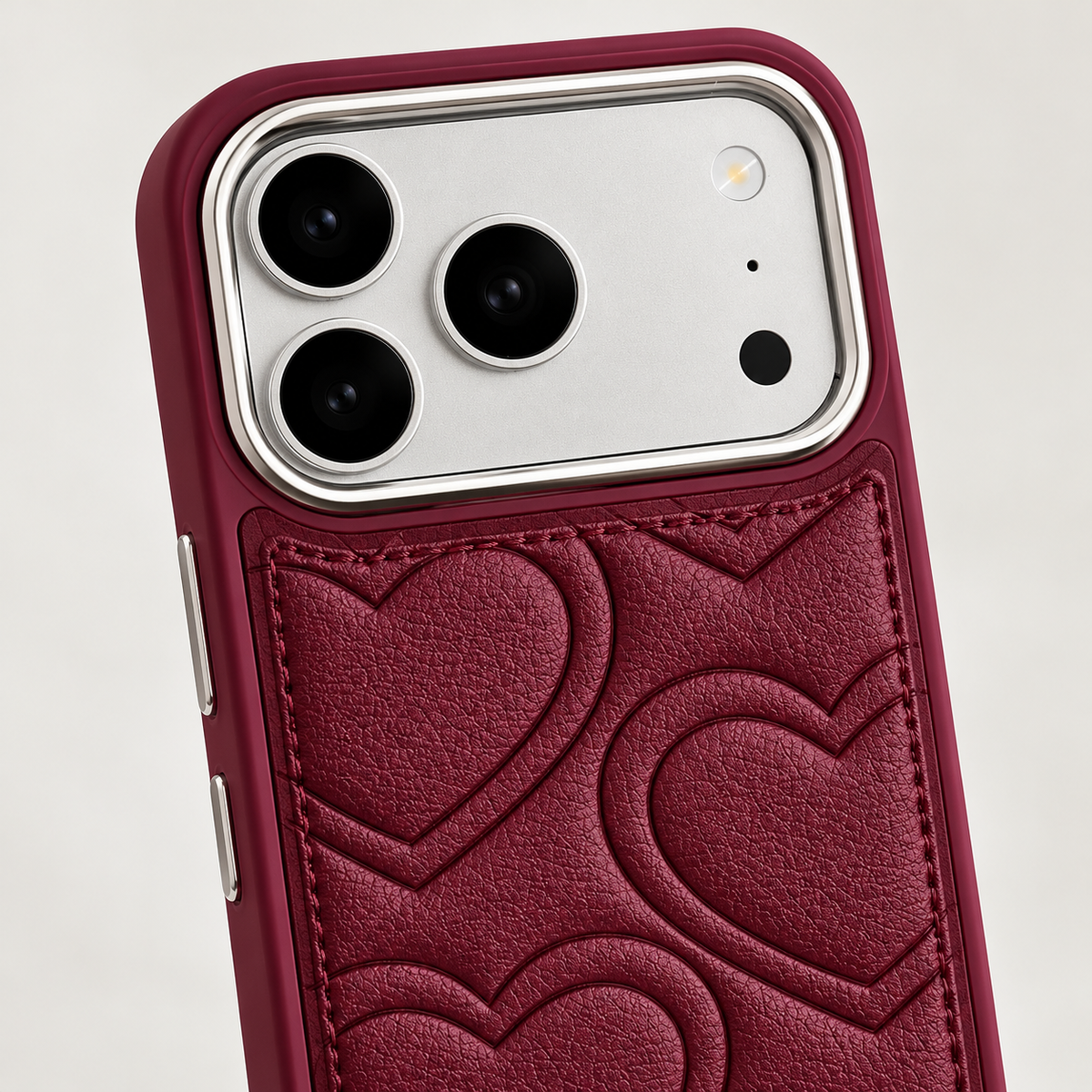 Textured heart iPhone case in Burgundy — camera surround and upper stitching detail.