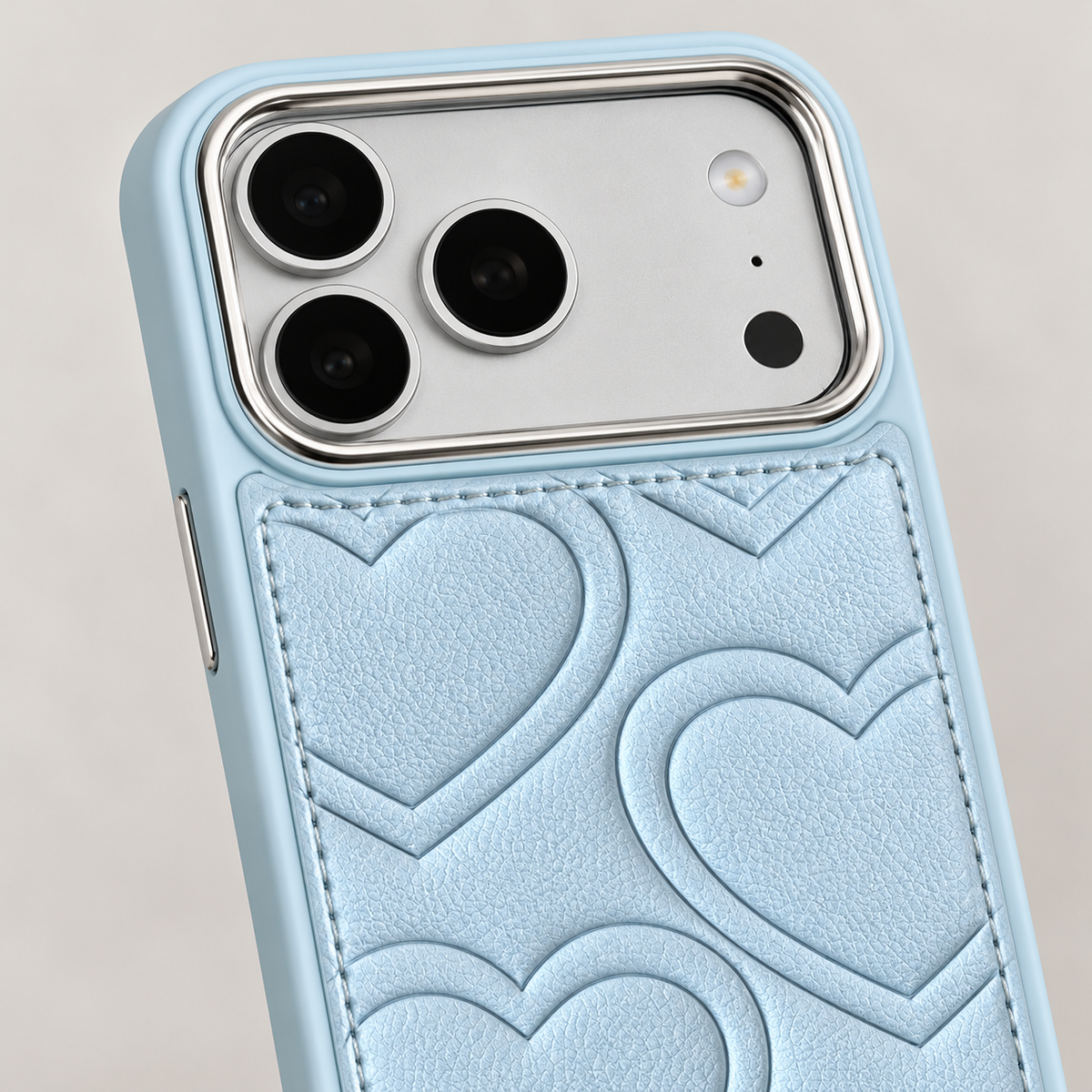 Textured heart iPhone case in Sky Blue — camera surround and upper stitching detail.