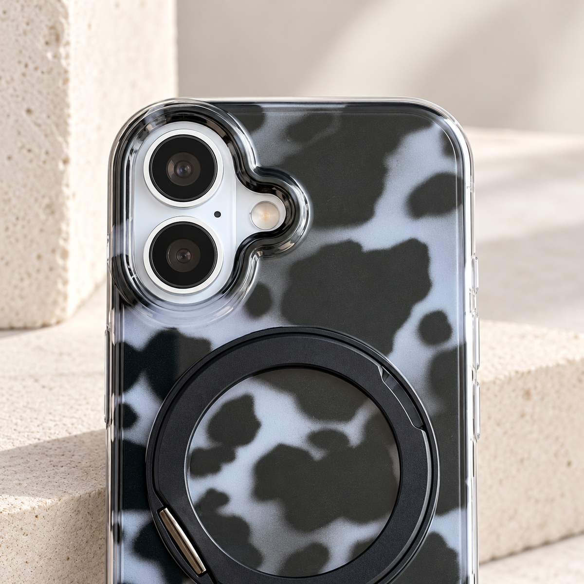 Grey tortoiseshell case camera-opening detail showing the photographed phone version.