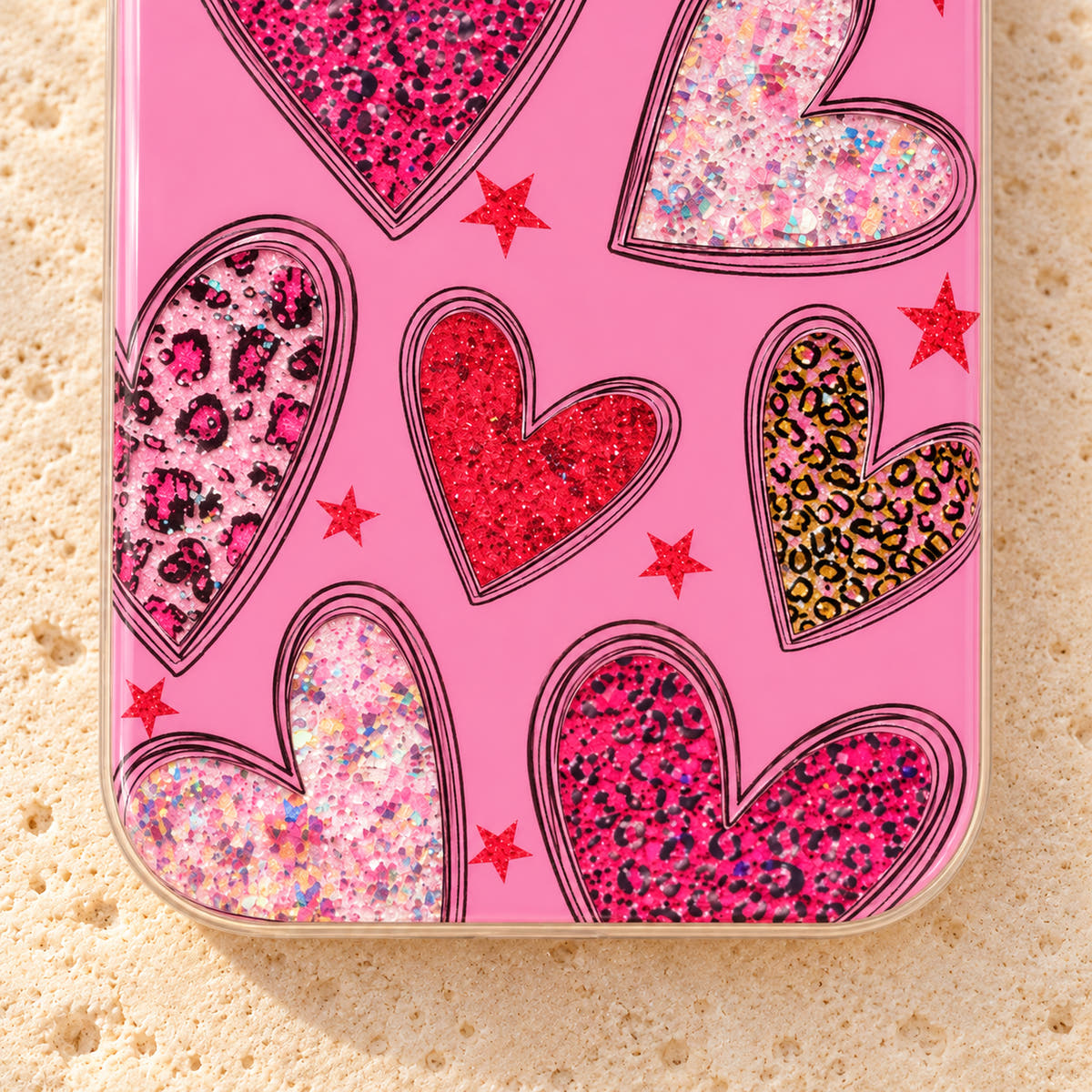 Lower-rear detail of the Valentina Sparkle Heart Pink case, showing red and leopard-pattern hearts beside its clear rounded edge.